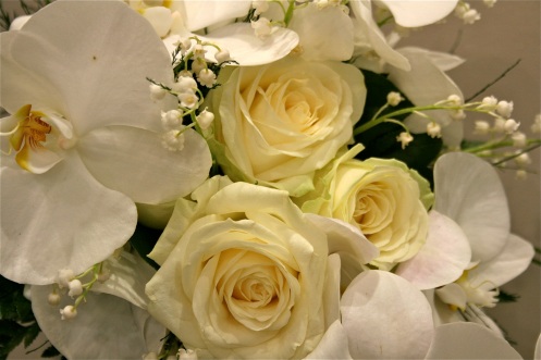 White bridal bouquet with Roses Orchids and Lily of the Valley