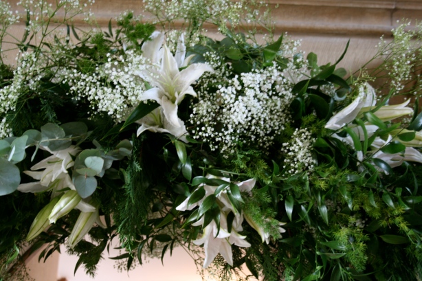 Detail of wedding arch with white babies breath and scented lilies