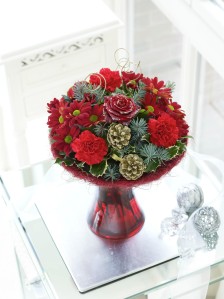 Christmas flowers in red glass vase