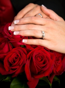 Engagement rings and a Bouquet of red Roses go Hand in Hand.