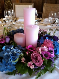 pink and purple flowers on wedding dinner table