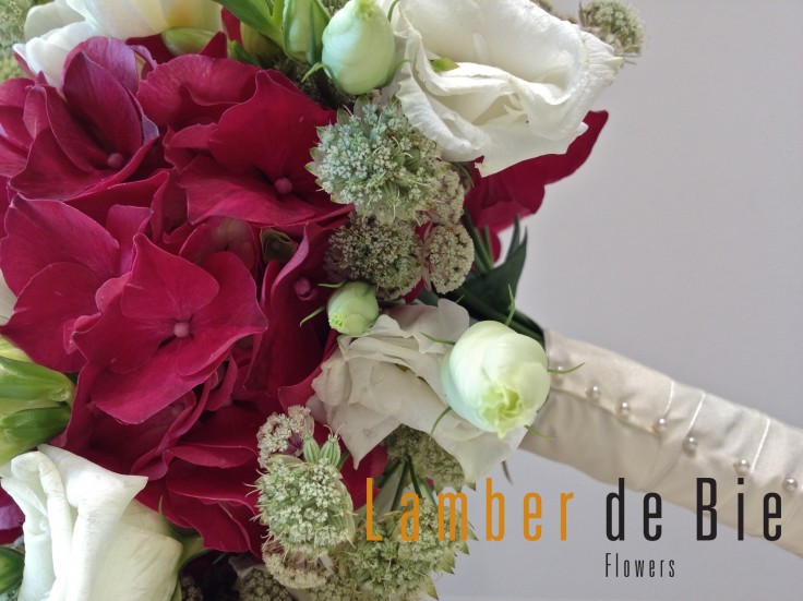 The hand tied bridal bouquet was finished with a delicate white satin ribbon.