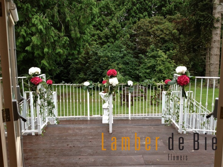 Balcony decorated with red and white Hydrangea flowers at the wedding reception